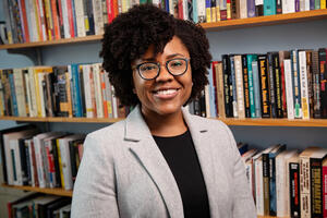 Professor Marsha Barrett infront of bookcase